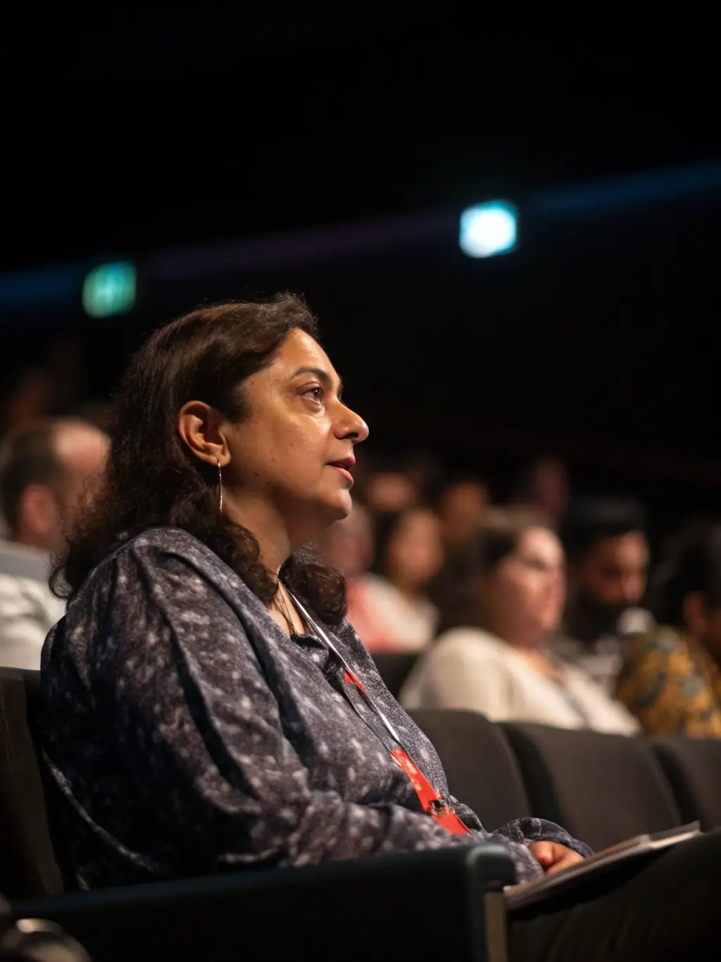 A professional headshot of Dr. Anya Sharma, a leading AI researcher, speaking at a conference, with a focus on her engaging presentation style and expertise in artificial intelligence.